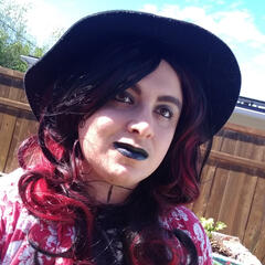 A picture of me wearing a black and red wig and a black hat